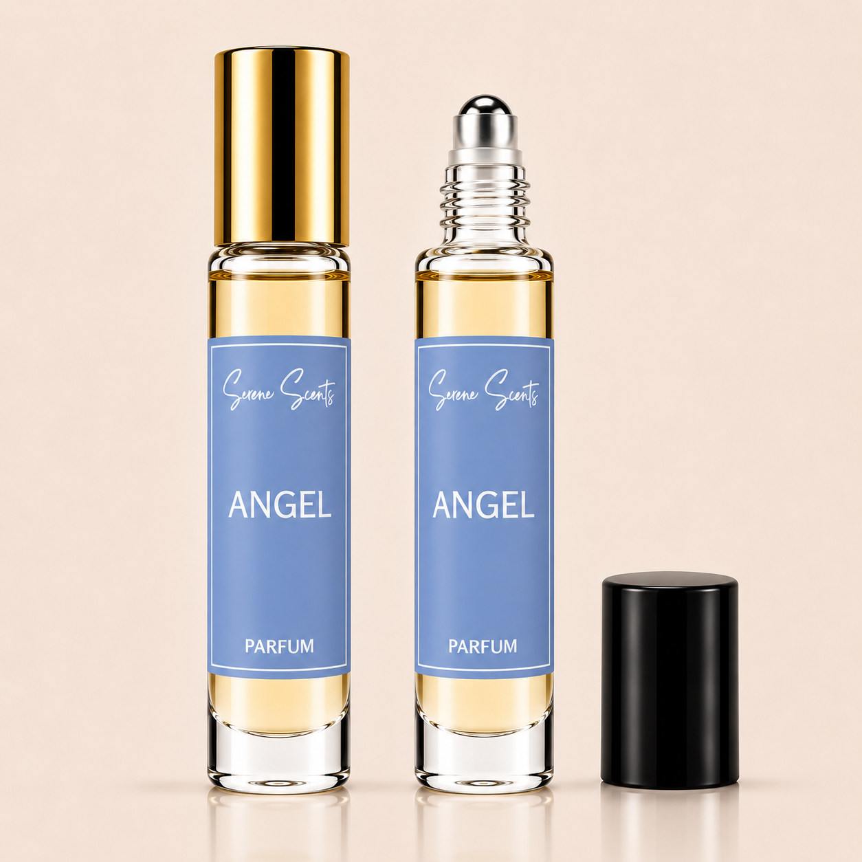 Two clear glass perfume roller bottles labeled 'Scent Sarts ANGEL PARFUM' with pale blue labels and pale yellow liquid, shown on a warm beige background. One bottle has a gold cap, one has a silver roller top, and a black cap sits beside them.