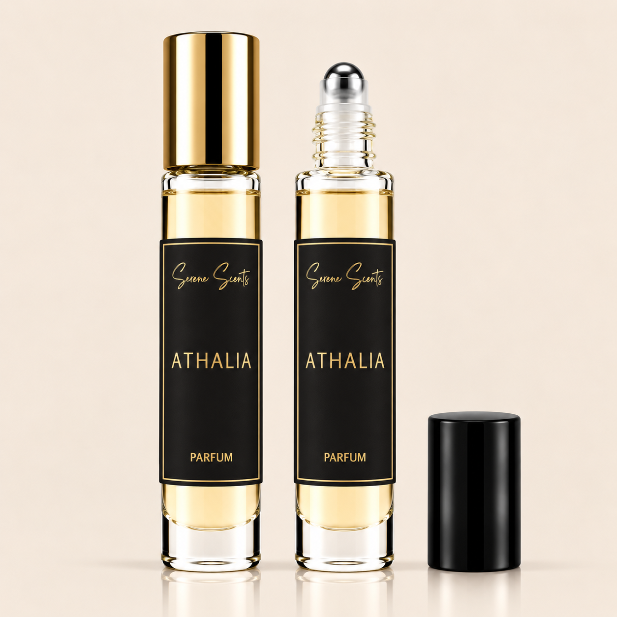 Two glass roll-on perfume bottles labeled 'Scent of Scents ATHALIA PARFUM' with black labels and gold lettering, one bottle with a gold cap and one with a clear cap showing the rollerball, plus a separate black cap on a light beige background.