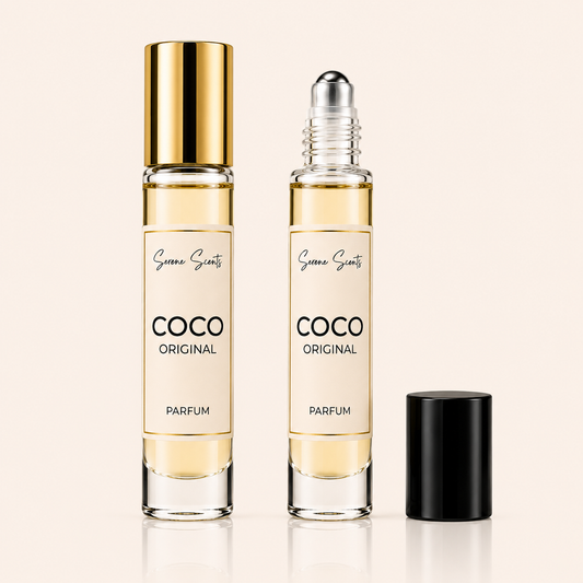 Two glass perfume rollerball bottles labeled 'COCO ORIGINAL PARFUM' by Scene Scents, shown on a light beige background. One bottle has a gold cap and the other is open with a black cap placed beside it.