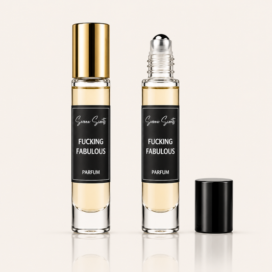 Two clear glass perfume roller bottles with pale yellow liquid, black labels reading 'Scenic Scents' and 'FUCKING FABULOUS PARFUM', one bottle with a gold cap and one with a black cap, shown on a light beige background.