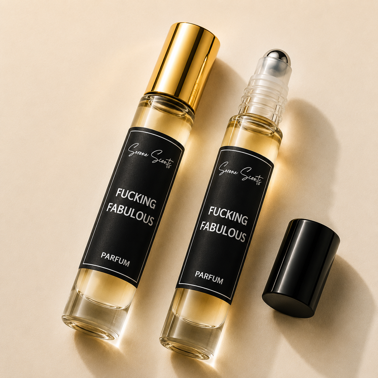 Two clear glass perfume roller bottles with black labels reading 'Fucking Fabulous' and 'Parfum' are arranged on a warm beige background. One bottle has a shiny gold cap and the other is open with its black cap placed beside it.