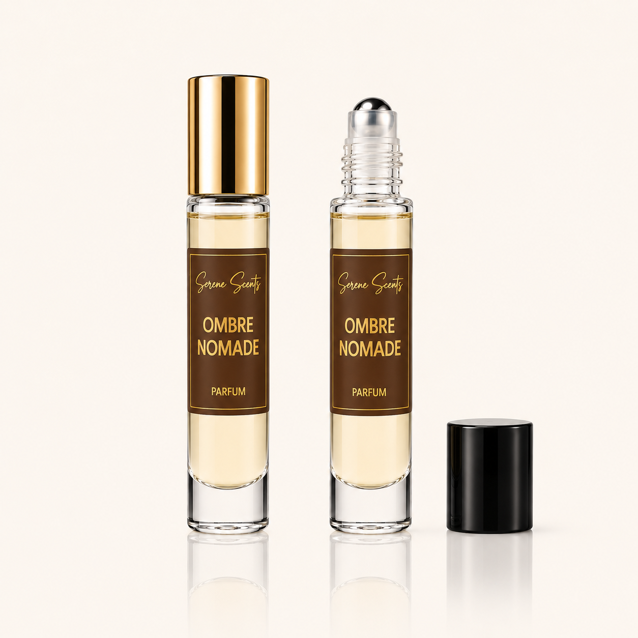 Two clear cylindrical perfume roller bottles with brown labels reading 'Sarah Sweets Ombre Nomade Parfum' are shown on a light beige background, one with a gold cap and one with a black cap removed and placed beside it.