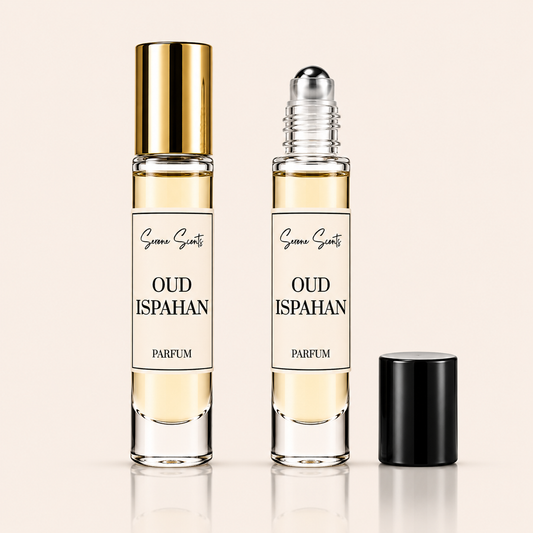 Two clear perfume roller bottles labeled 'Sanaa Scents Oud Ispahan Parfum' on a light beige background, with one bottle showing a gold cap and the other showing a silver roller ball, plus a separate black cap beside them.