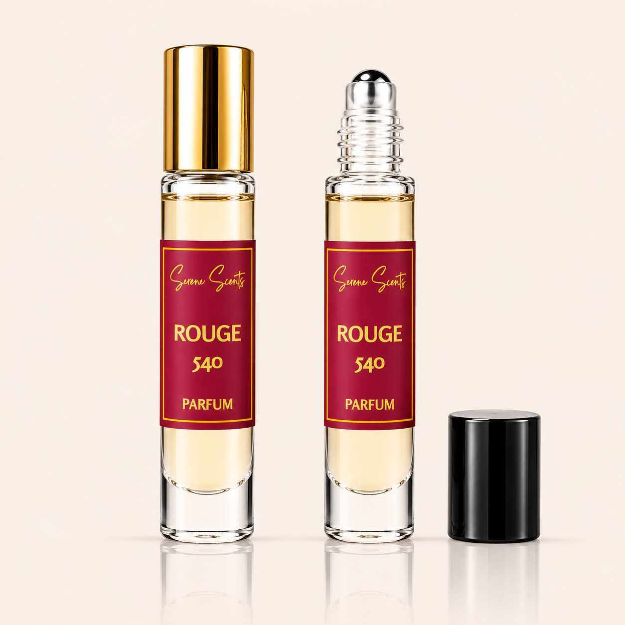 Two clear glass perfume roller bottles with pale yellow liquid, red labels reading 'Succé Scents ROUGE 540 PARFUM', and gold-toned caps, shown on a light beige background with one bottle cap placed beside it.