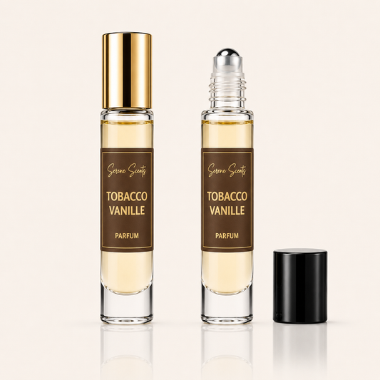Two clear glass perfume rollerball bottles labeled 'Scenes Scenery Tobacco Vanille Parfum' on a light beige background, with one bottle showing a gold cap and the other showing a silver rollerball, plus a separate black cap standing beside them.